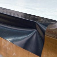 Apply tape to one side, then fold over the edge and underneath